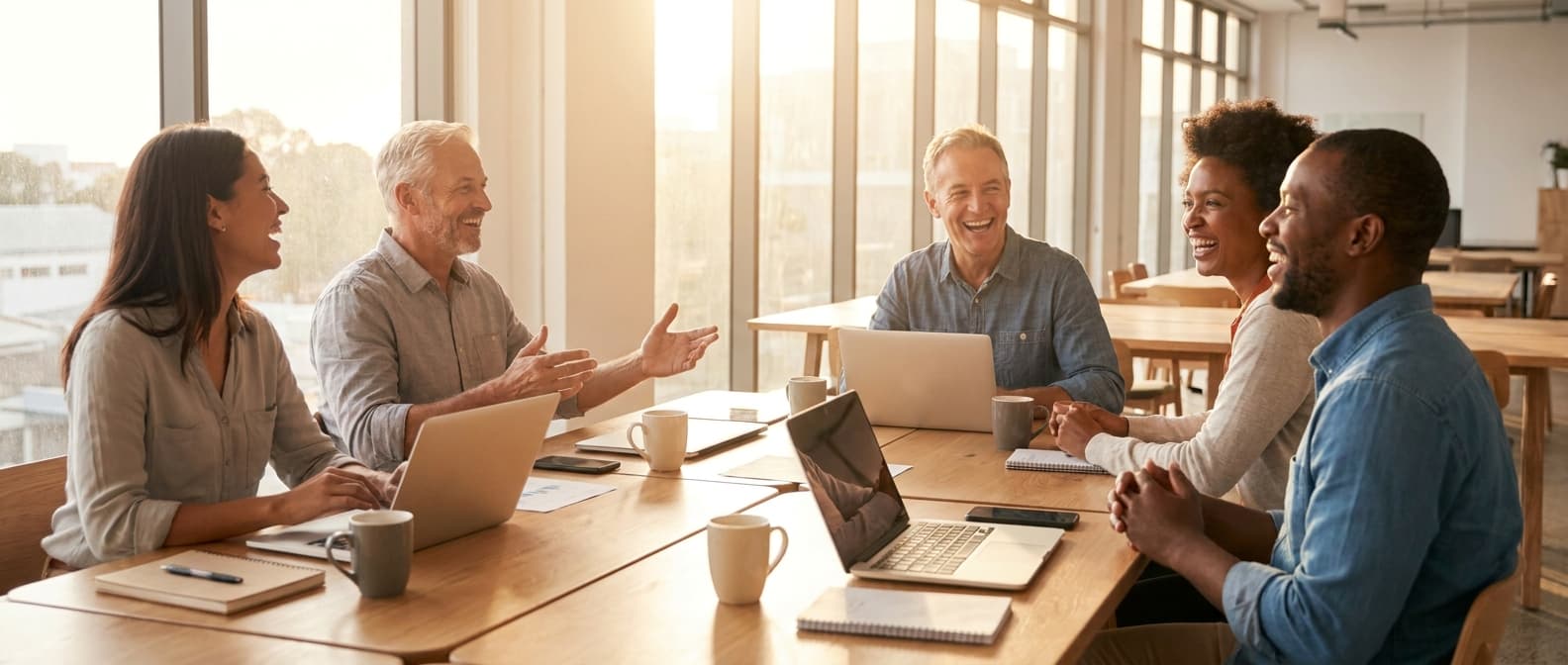 A manager and an employee talking at a desk.